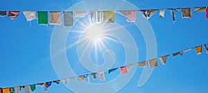 Karneval Hintergrund - Viele bunte Lumpen an Leine auf der StraÃÅ¸e, als Schmuck fÃÂ¼r Fasching, mit blauem Himmel und photo